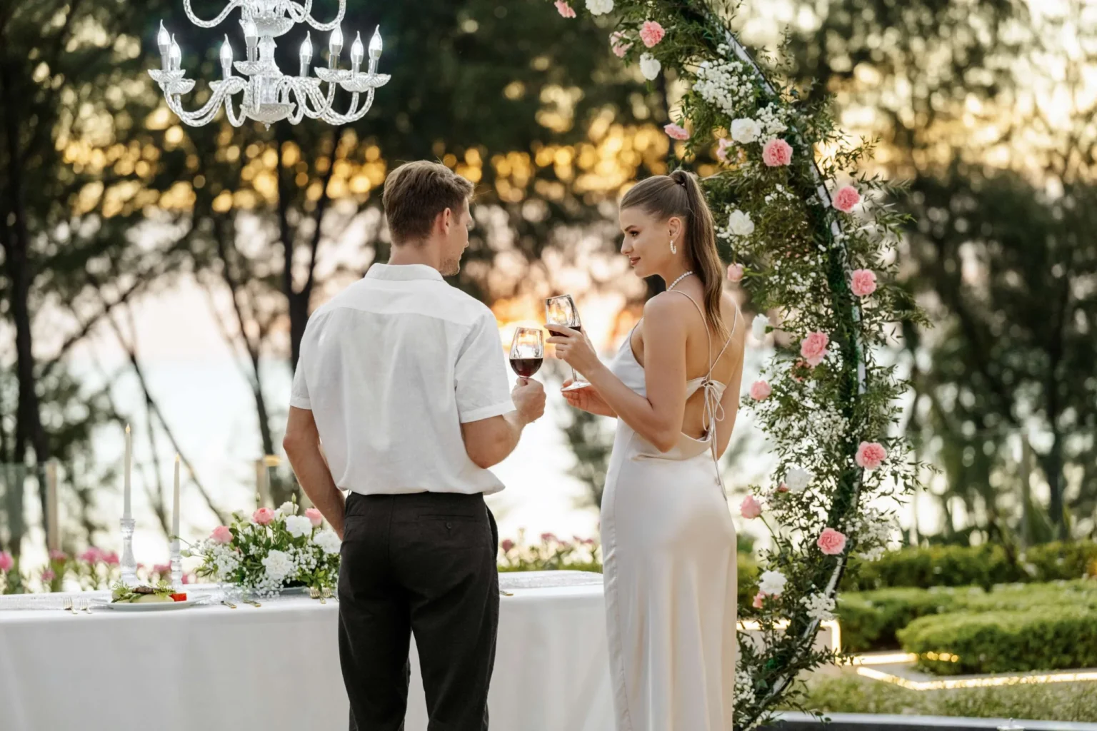 Couple-Enjoying-romantic-dinner-resort-holiday-scaled